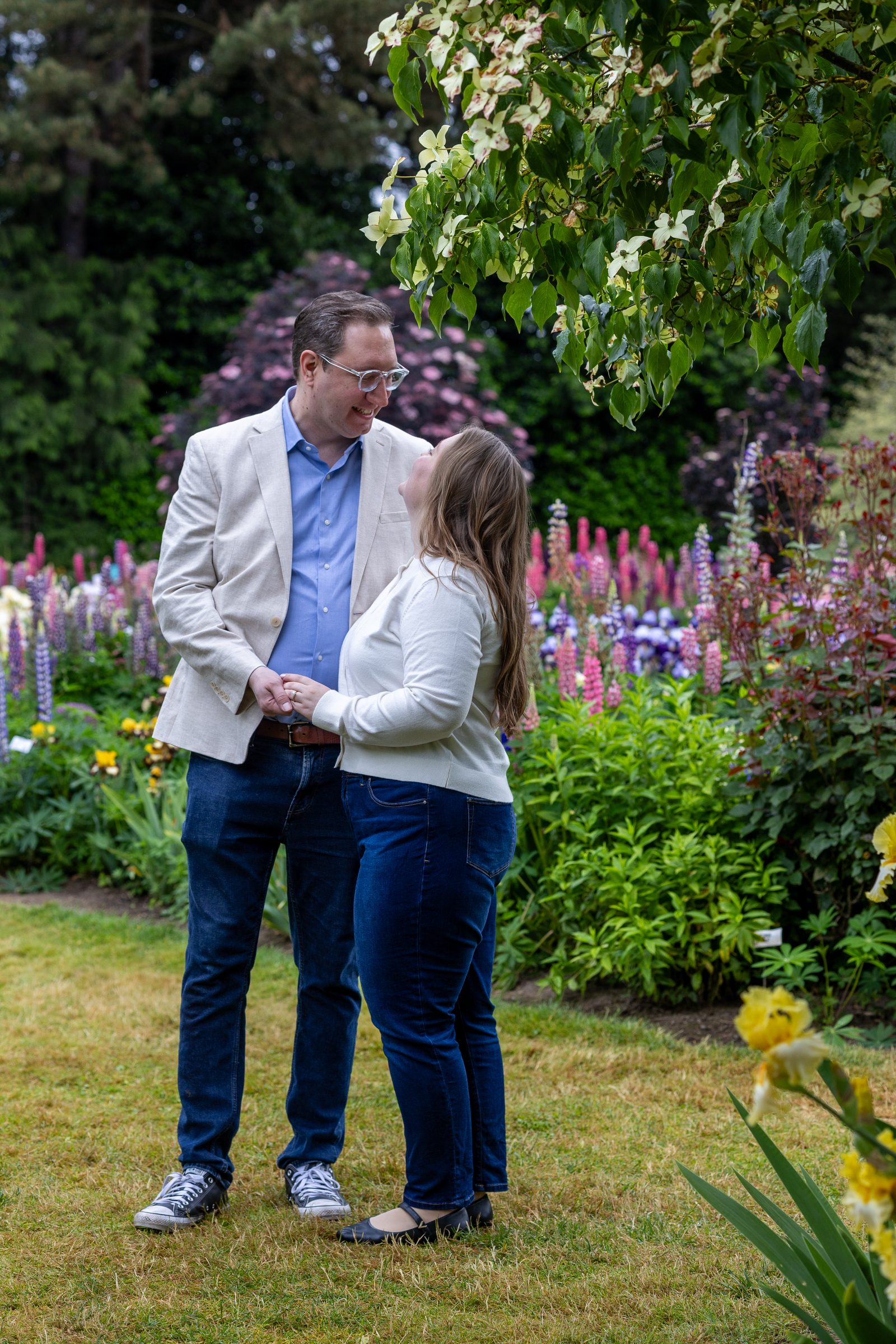 Rachel and Daniel looking at each other under a tree