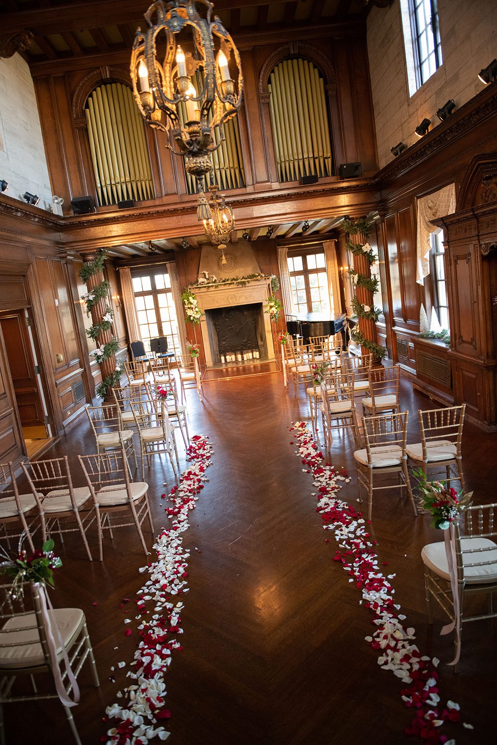 Music Room aisle with rose petals and candlelit greenery